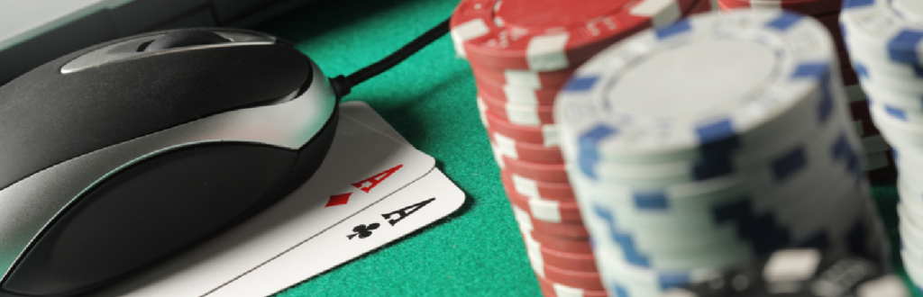 Two aces, poker chips and a mouse representing online poker.