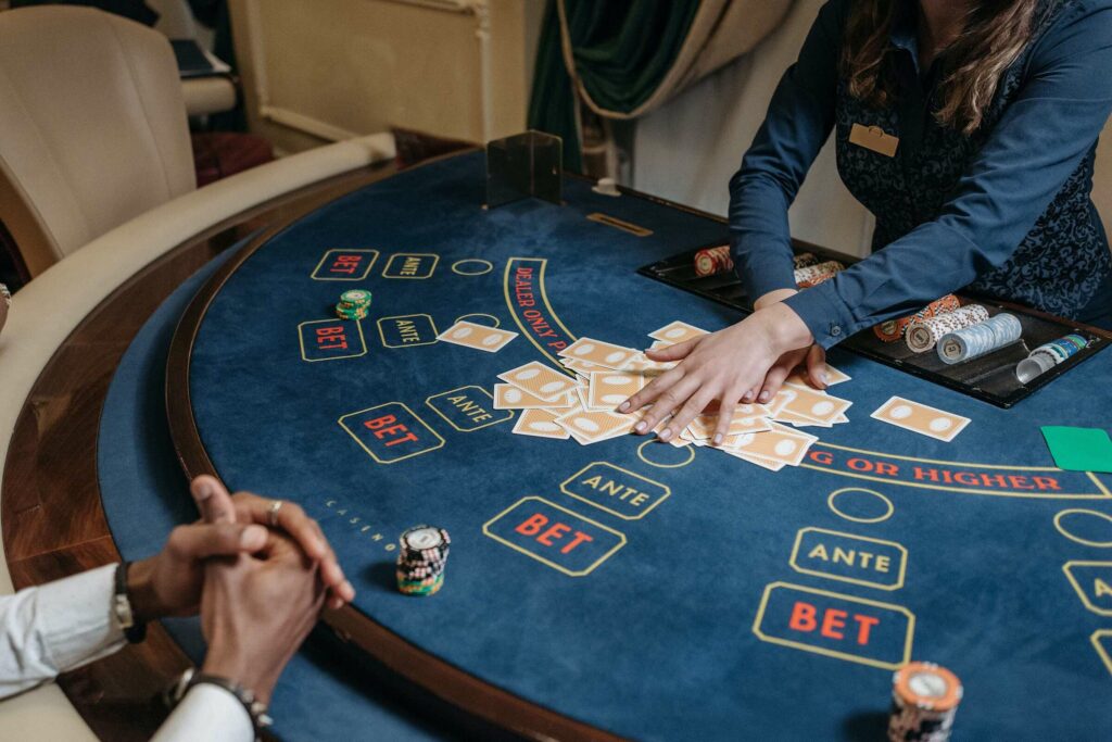 A dealer deals cards on a baccarat table
