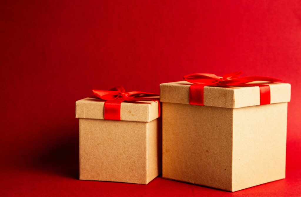 Two gift boxes with red ribbon
