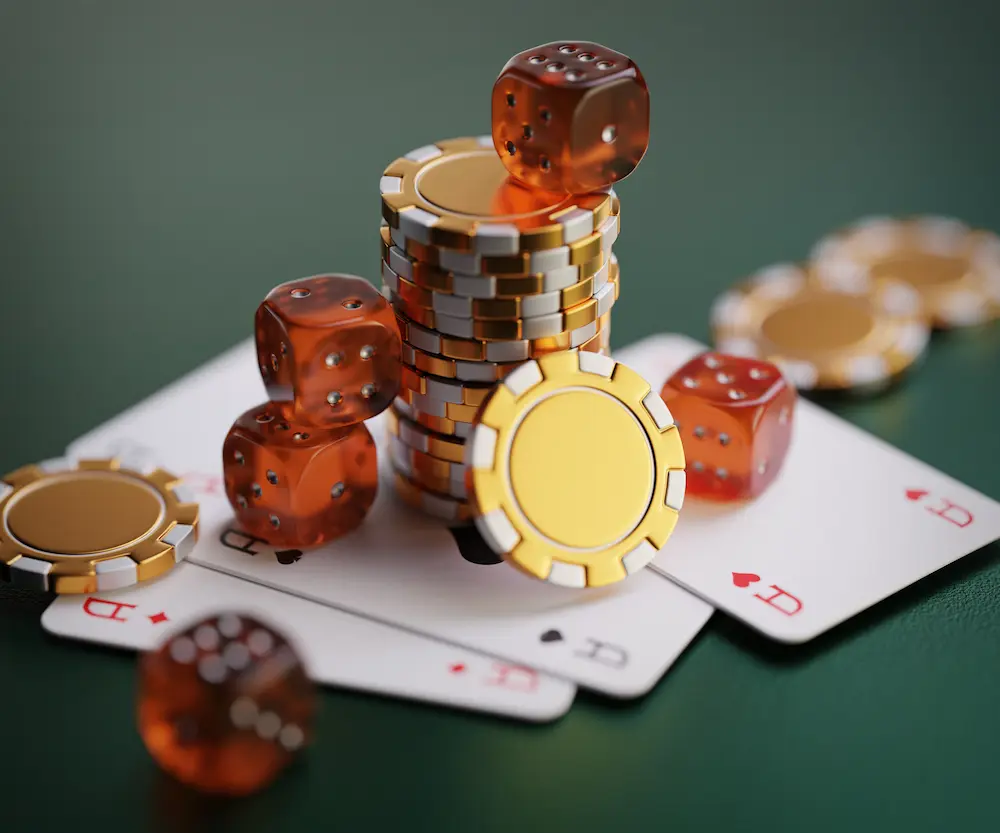 Four aces, multiple dice, and a stack of chips on a casino table